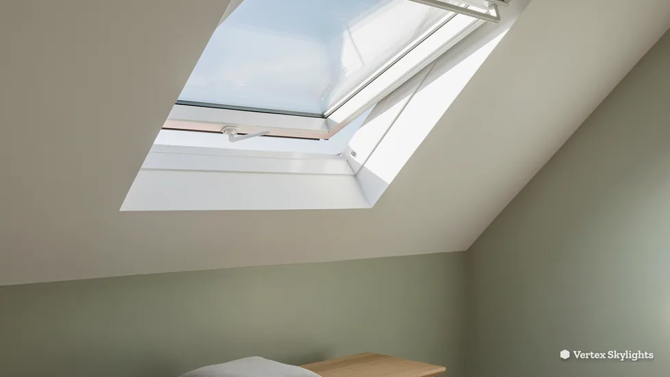 A roof window in a sloping white ceiling, sky beyond the glass